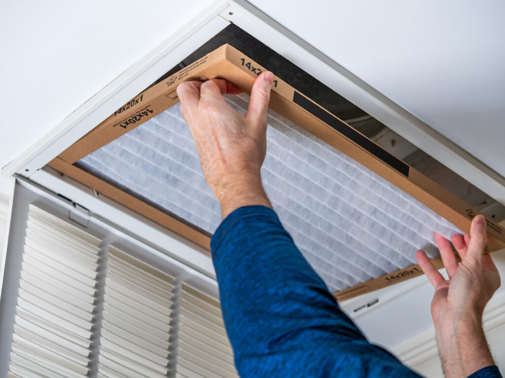 HVAC technician replacing a home air filter in Los Altos
