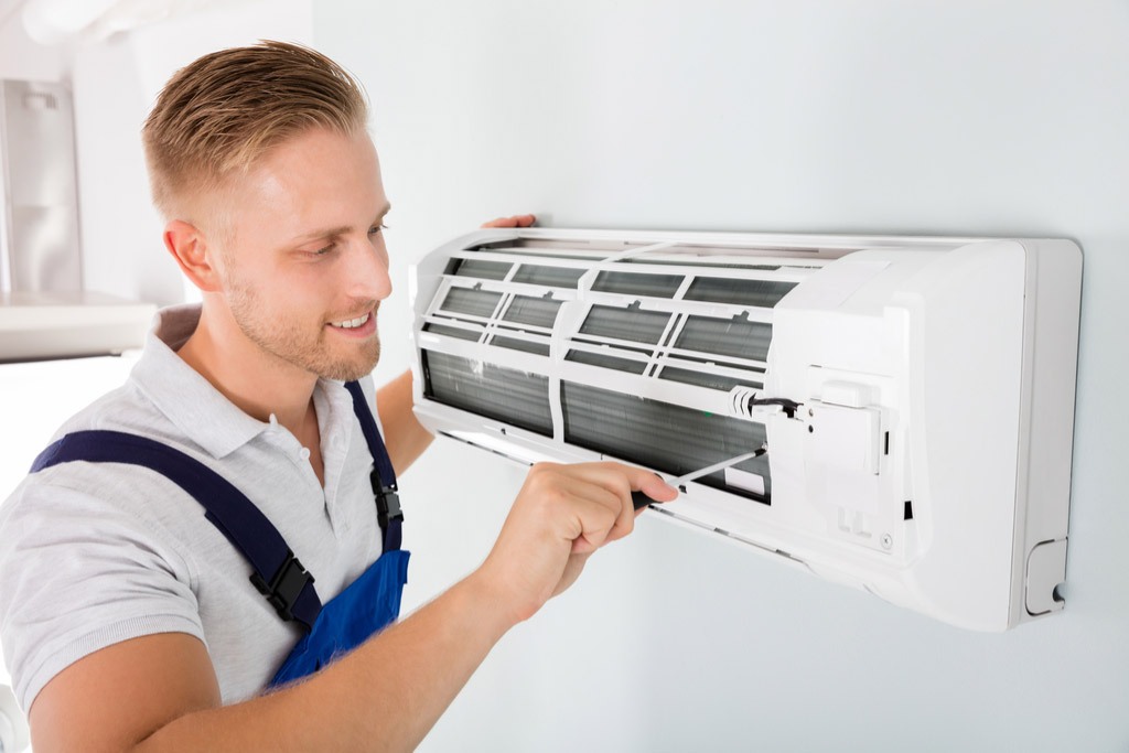HVAC technician maintaining a ductless air conditioner in Los Altos