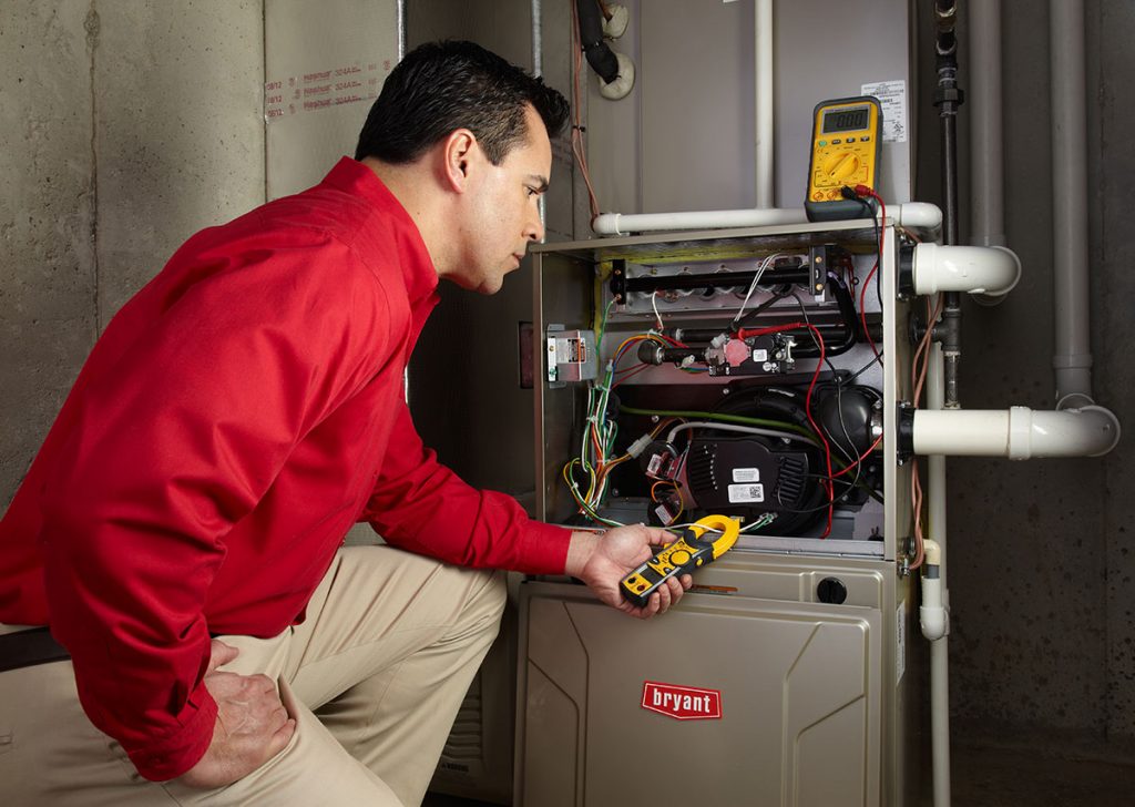 Heating technician diagnosing a furnace repair in Los Altos