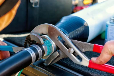 Technician repairing an industrial pipe connection in Los Altos