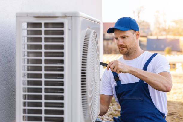 HVAC technician servicing an outdoor air conditioner in Los Altos